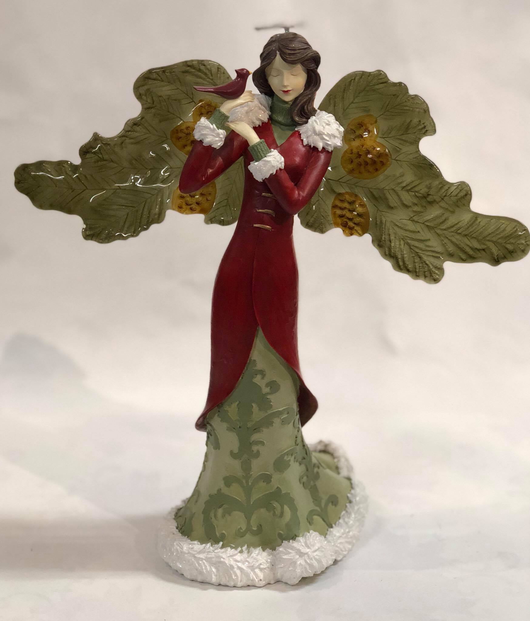 Angel holding cardinal figurine