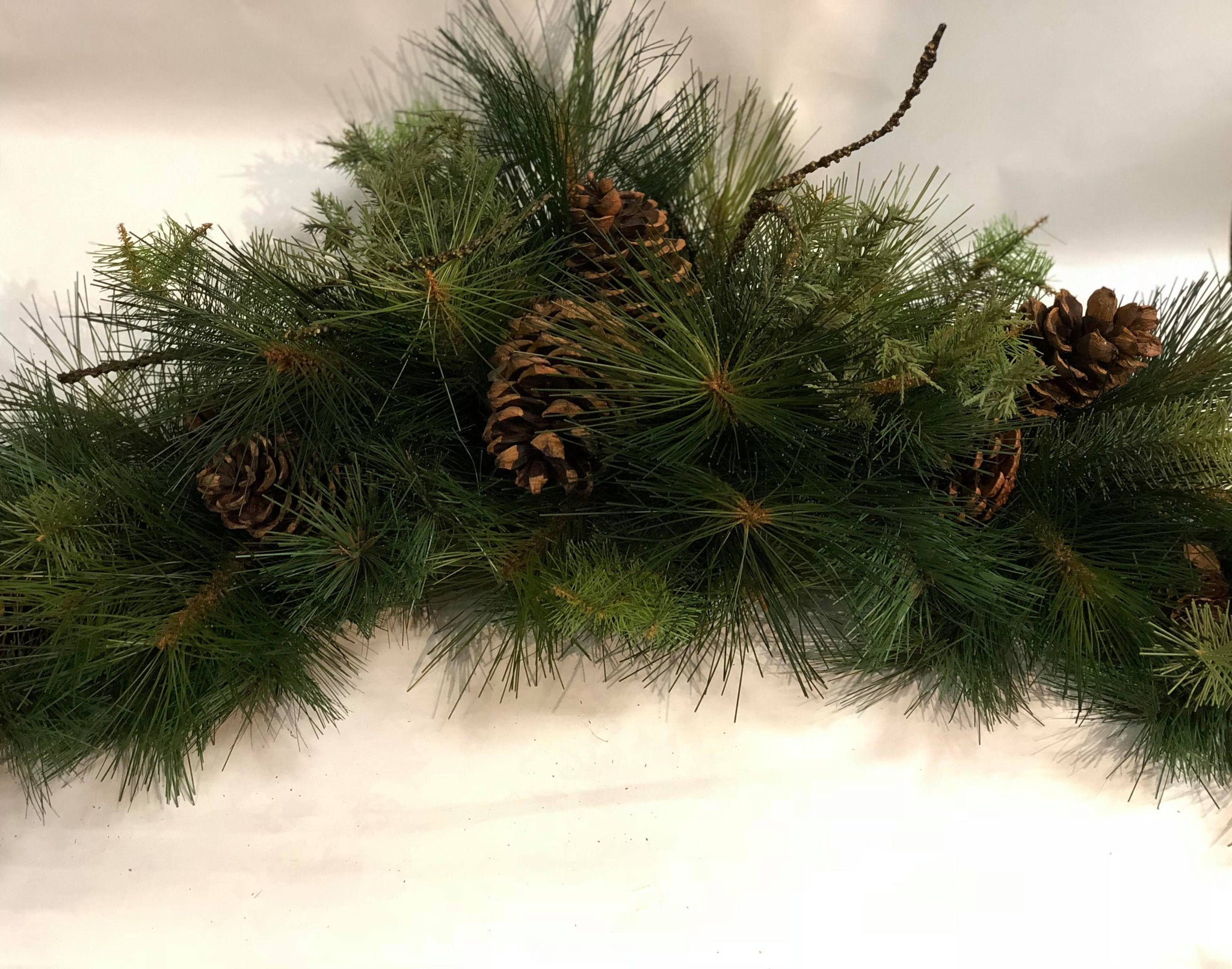Mixed winter green arched swag