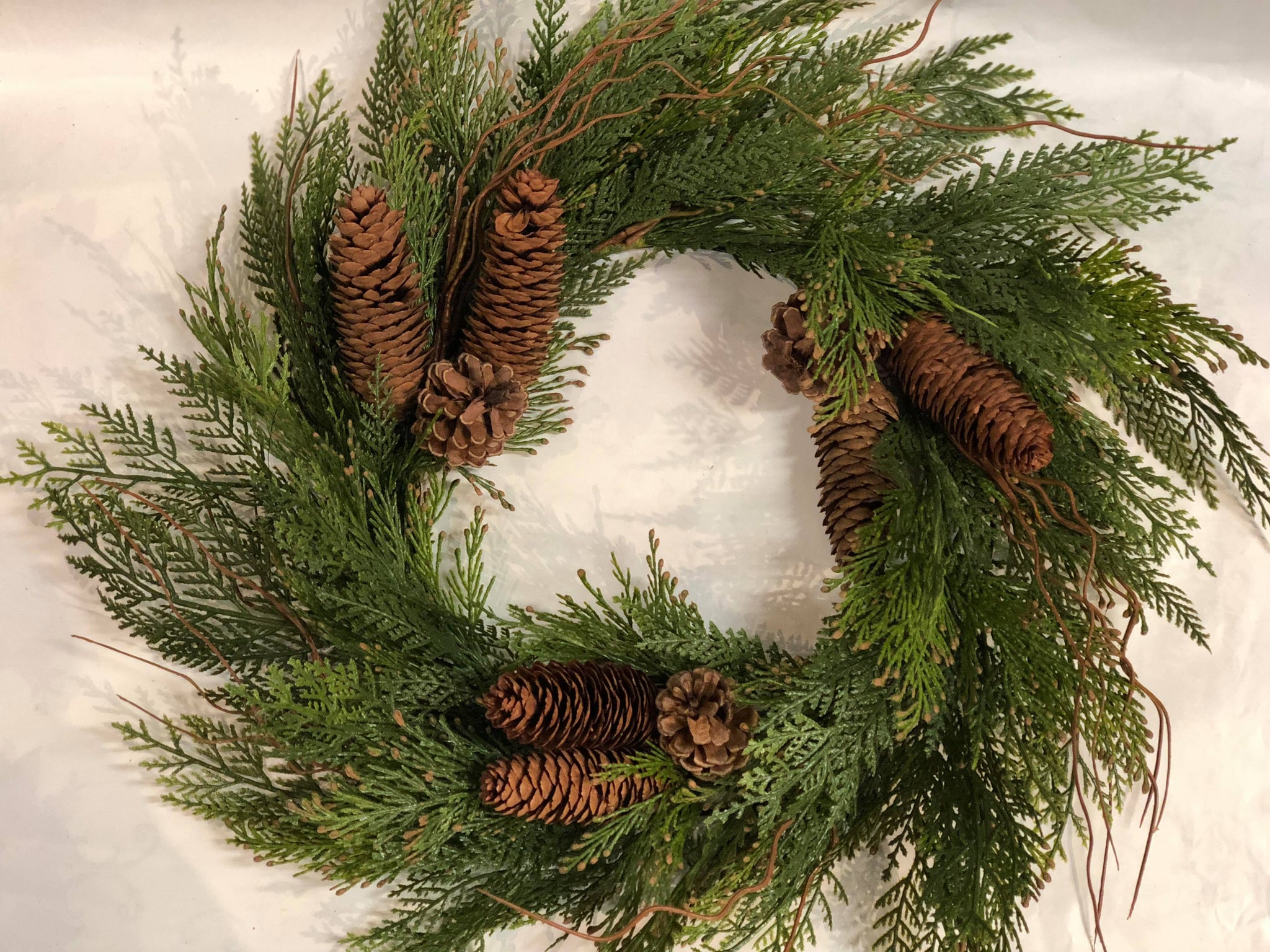 Mixed green wreath with pinecones